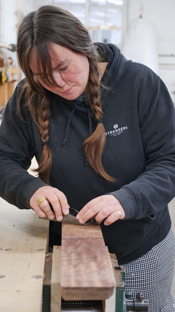 A woman working on wood